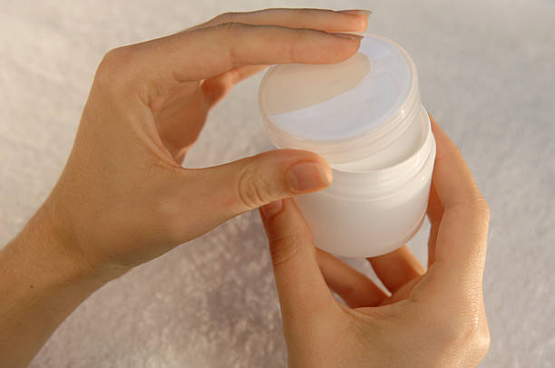 hand holding white generic cosmetics container